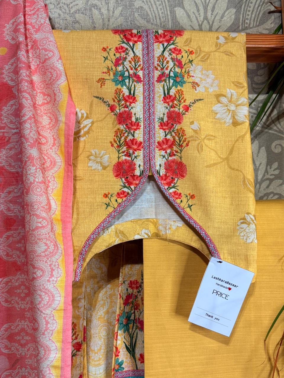 Yellow garment with floral patterns on a table
