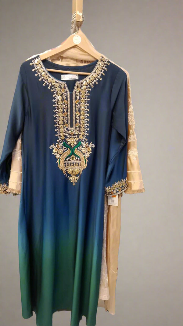 Blue and green dress with intricate gold embroidery on a hanger.